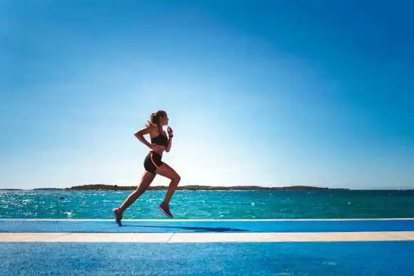 Woman running showing strong leg muscle Springs Mire
